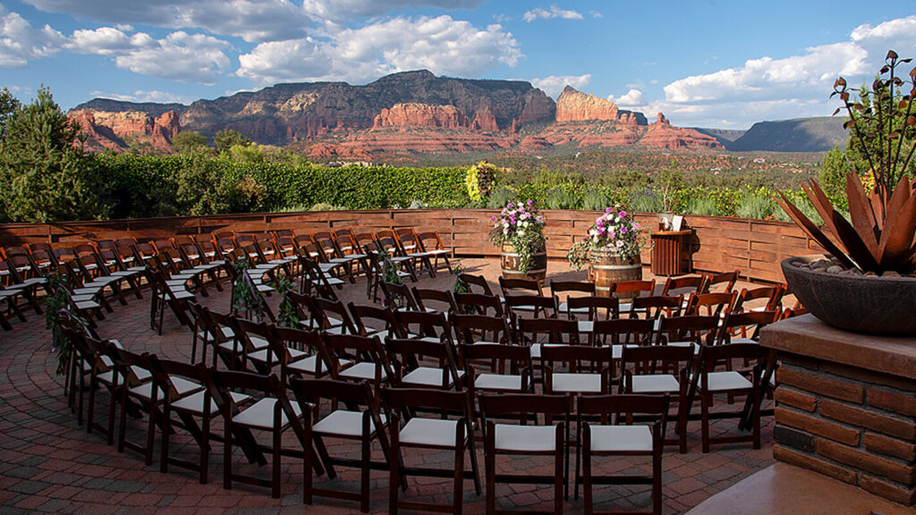 Ceremony terrace at Agave of Sedona set with chairs and florals facing the red rocks