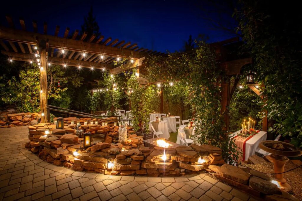 Wedding Gardens at Lantern Light Inn in Sedona at dusk, with string lights, lanterns, and candlelit tables