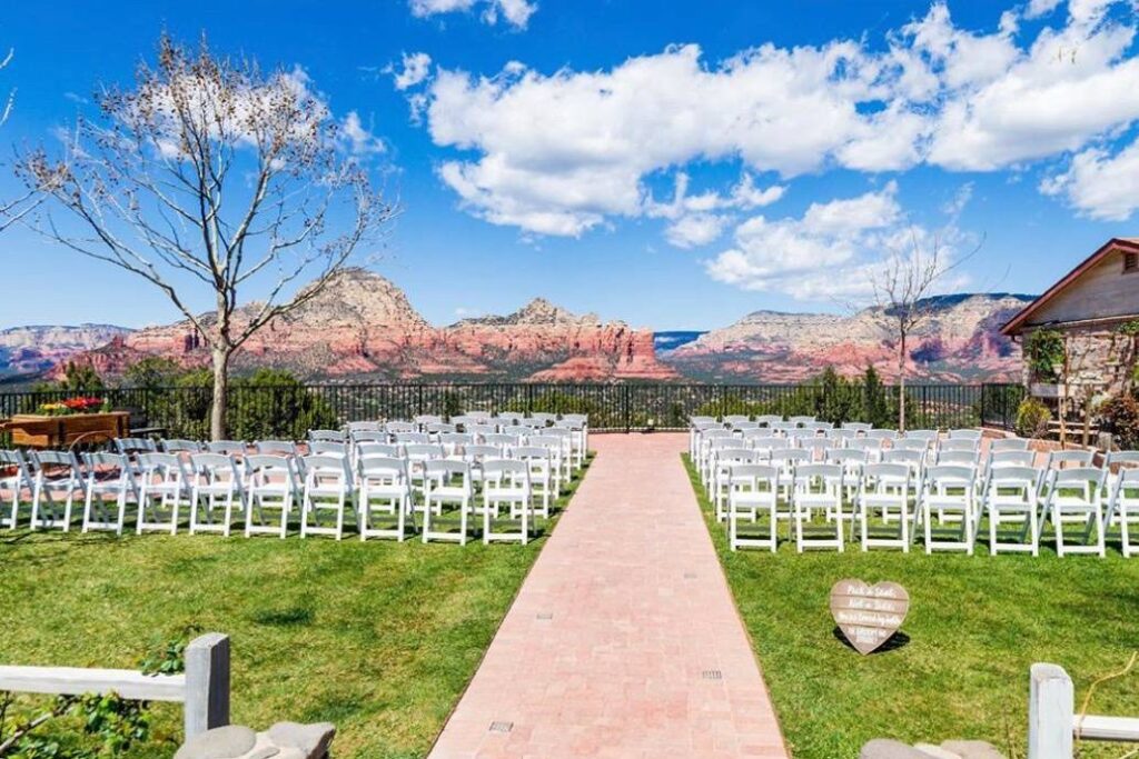 Ceremony lawn at Sky Ranch Lodge on Airport Mesa with white chairs facing the Sedona red rocks